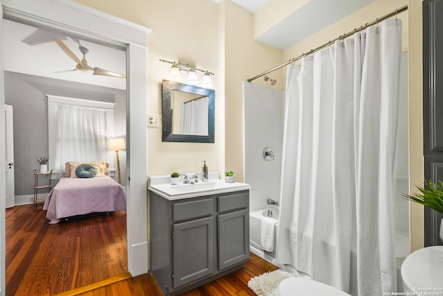 full bathroom featuring toilet, hardwood / wood-style flooring, shower / bath combo, and ceiling fan