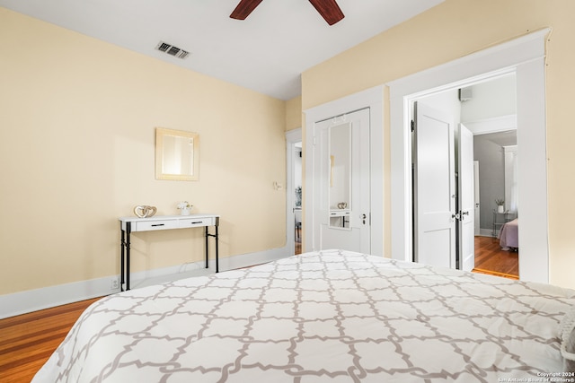 bedroom featuring a closet, light hardwood / wood-style floors, and ceiling fan