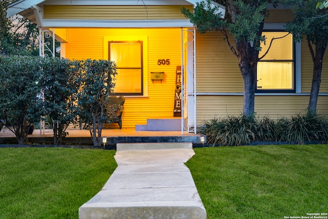 entrance to property featuring a yard