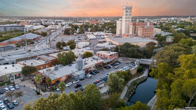 aerial view at dusk featuring a water view