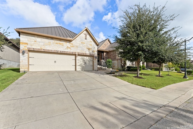 view of front of home featuring a garage and a front lawn