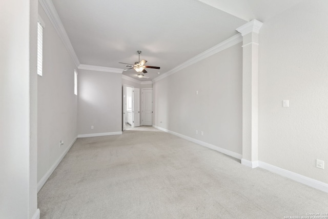 unfurnished room featuring ceiling fan, decorative columns, ornamental molding, and light colored carpet