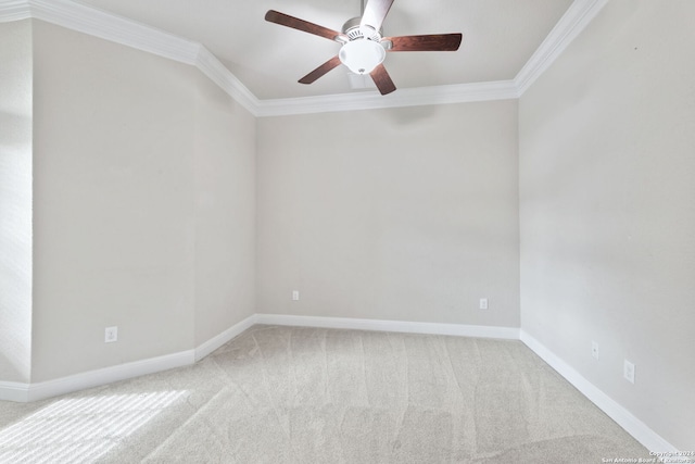 carpeted spare room with crown molding and ceiling fan