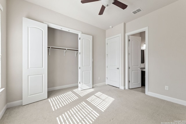 unfurnished bedroom featuring a closet, ceiling fan, and light carpet