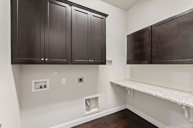 laundry area featuring cabinets, dark hardwood / wood-style flooring, gas dryer hookup, hookup for a washing machine, and electric dryer hookup