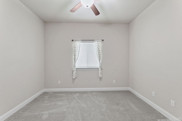 empty room with light carpet and ceiling fan