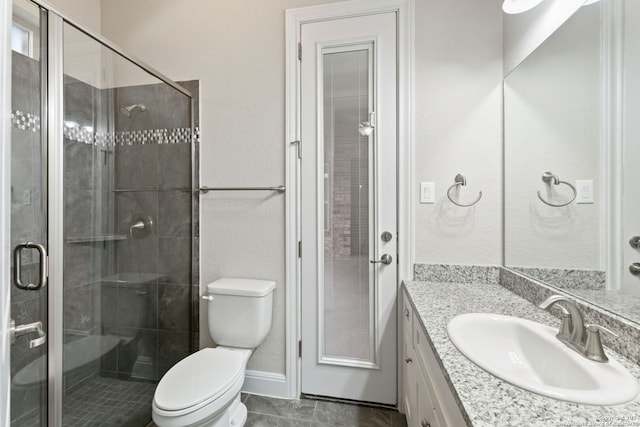 bathroom with toilet, an enclosed shower, vanity, and tile patterned floors