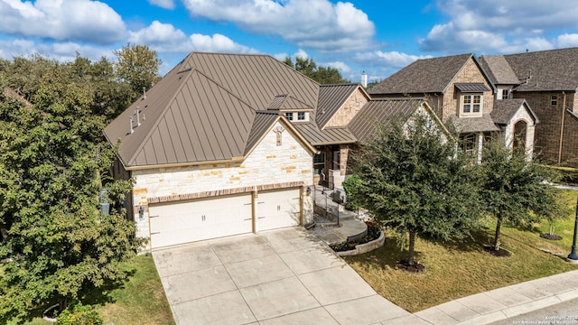 view of front of house featuring a garage and a front lawn