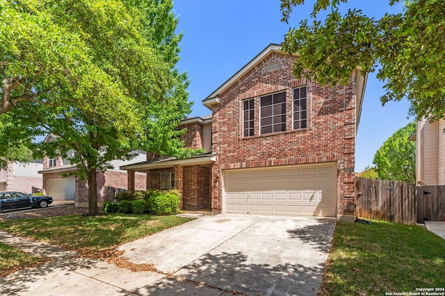 front of property with a front yard and a garage