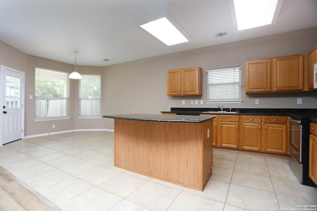 14514 Redwood Vly, Helotes, TX 78023 - kitchen featuring a sink, electric stove, dark countertops, a kitchen island, and light tile patterned floors