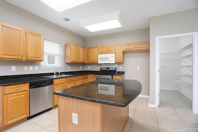 14514 Redwood Vly, Helotes, TX 78023 - kitchen with stainless steel appliances, a sink, light tile patterned flooring, a kitchen island, and dark stone counters