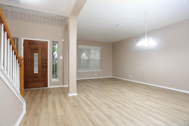 14514 Redwood Vly, Helotes, TX 78023 - foyer featuring light wood-style flooring, stairway, baseboards, a chandelier, and arched walkways