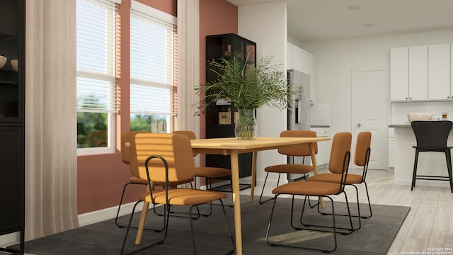 dining room featuring light hardwood / wood-style flooring and plenty of natural light