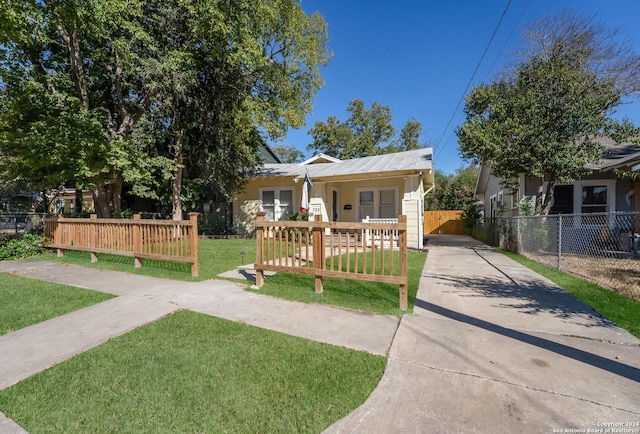 bungalow with a porch and a front lawn