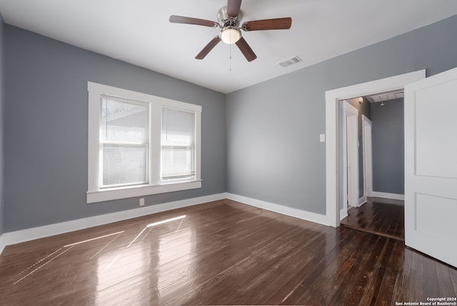 unfurnished room with dark wood-type flooring and ceiling fan