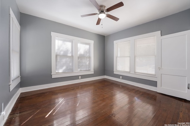 unfurnished room featuring dark wood-type flooring and ceiling fan