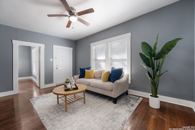 living room with dark wood-type flooring and ceiling fan