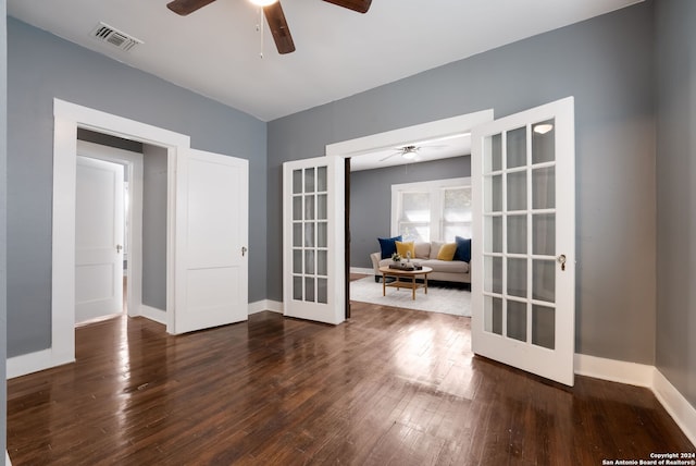 spare room featuring french doors, dark hardwood / wood-style floors, and ceiling fan