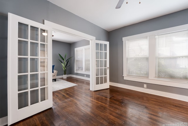 interior space featuring french doors, ceiling fan, and dark wood-type flooring