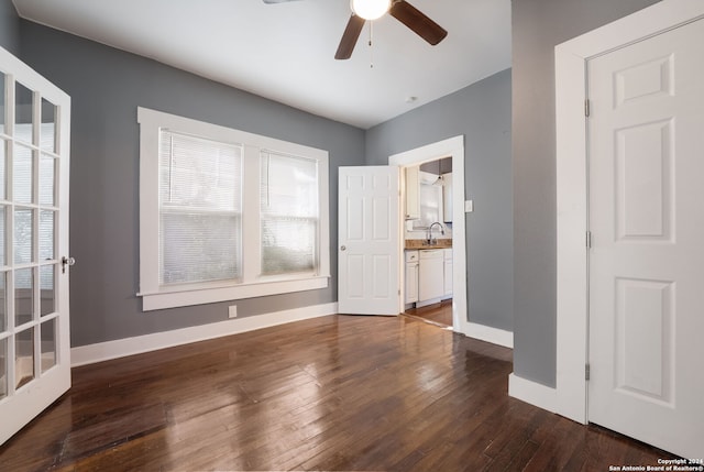 empty room featuring sink, dark wood-type flooring, and ceiling fan