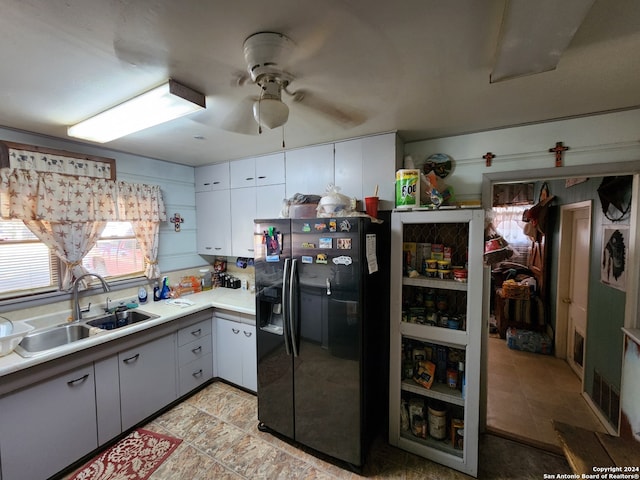 kitchen featuring ceiling fan, sink, and black fridge with ice dispenser