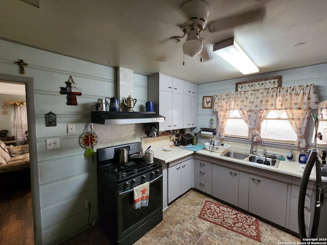 kitchen featuring white cabinets, black gas range, ceiling fan, sink, and ventilation hood