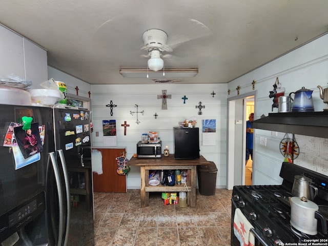 kitchen with black refrigerator, gas stove, and black fridge with ice dispenser