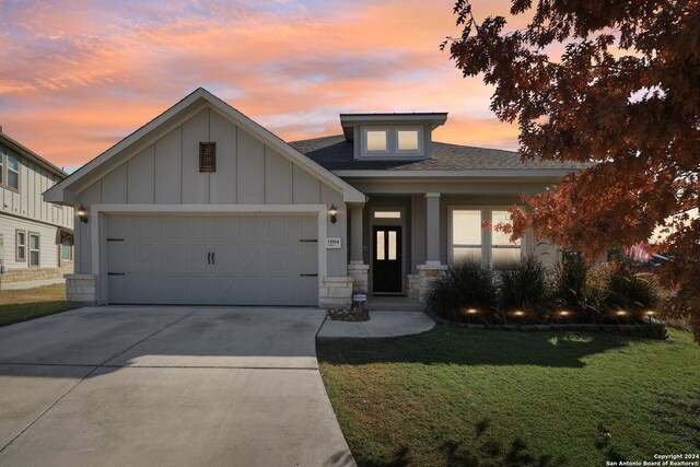 view of front of house featuring a garage and a lawn