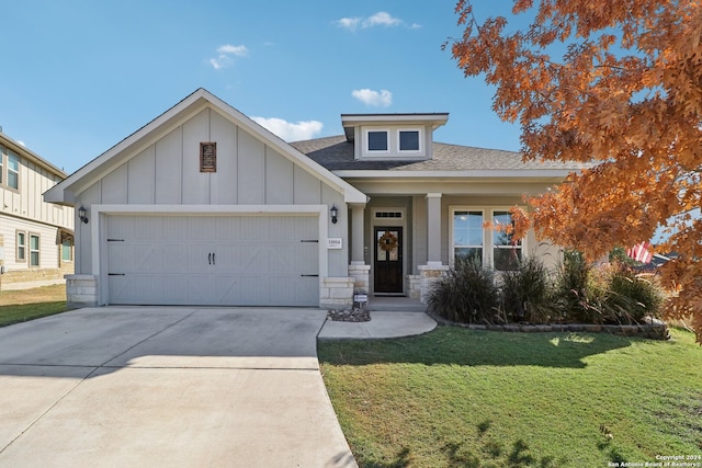 view of front facade with a front yard and a garage