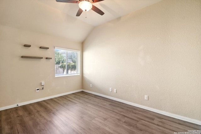 unfurnished room with ceiling fan, lofted ceiling, and dark hardwood / wood-style flooring