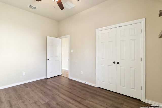 unfurnished bedroom with a closet, dark wood-type flooring, and ceiling fan