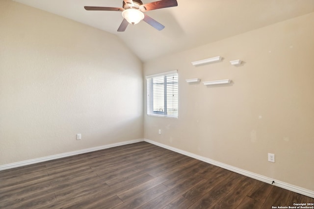 spare room featuring ceiling fan, dark wood-type flooring, and vaulted ceiling