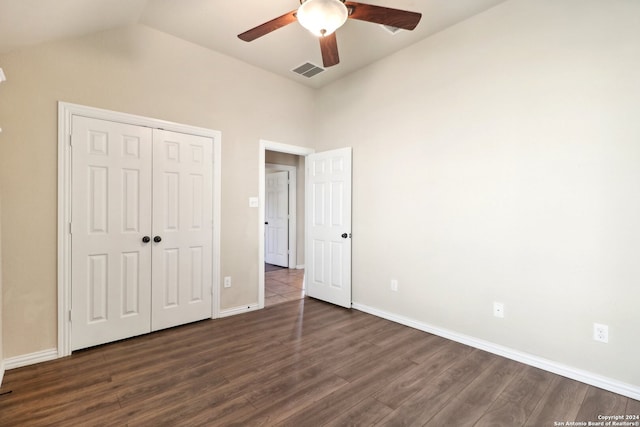 unfurnished bedroom with vaulted ceiling, ceiling fan, a closet, and dark hardwood / wood-style flooring