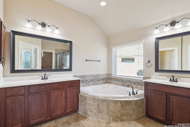 bathroom featuring vanity, independent shower and bath, and lofted ceiling