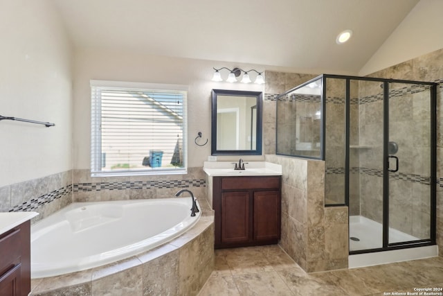 bathroom featuring vanity, lofted ceiling, and plus walk in shower