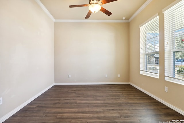 empty room with dark hardwood / wood-style flooring, ornamental molding, and a wealth of natural light