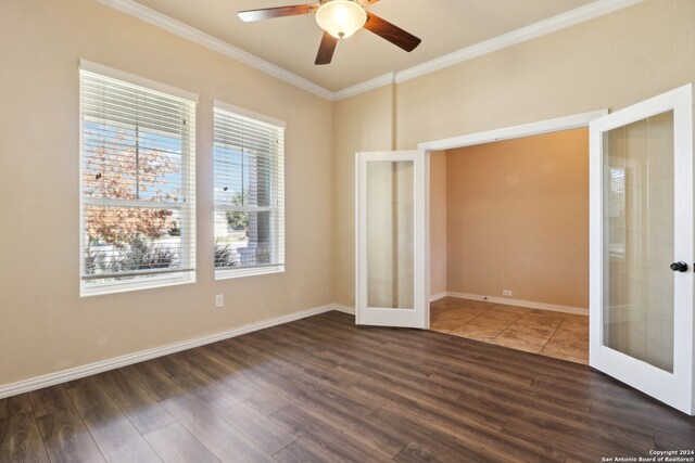 unfurnished bedroom with french doors, crown molding, dark hardwood / wood-style floors, and ceiling fan