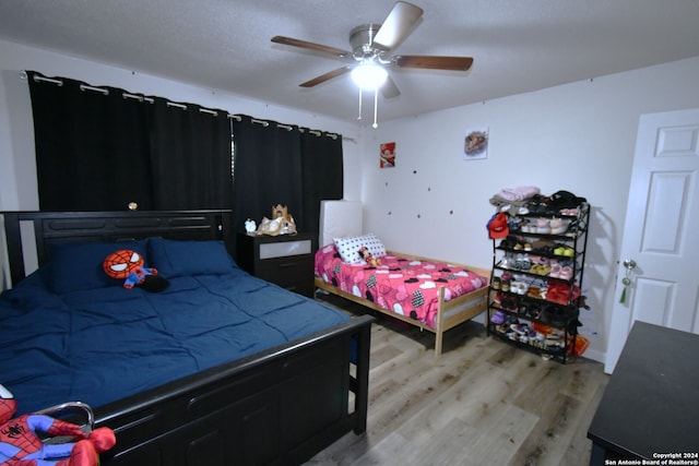 bedroom featuring light hardwood / wood-style flooring and ceiling fan