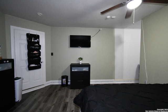 bedroom with dark hardwood / wood-style flooring and ceiling fan