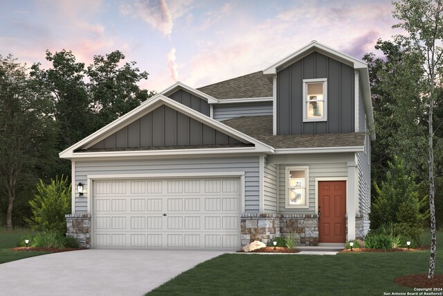 craftsman house featuring a garage and a lawn