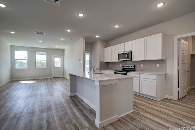 kitchen featuring white cabinetry, hardwood / wood-style floors, and stainless steel appliances