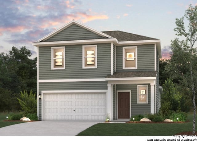 view of front of property with a garage and a lawn