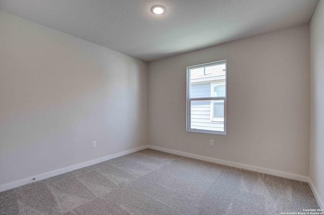 unfurnished room featuring carpet floors and a textured ceiling