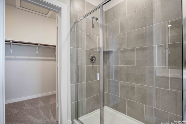 bathroom with a shower with door