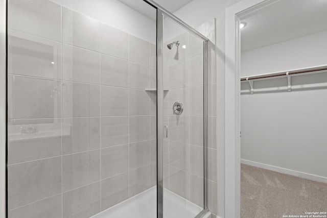 10719 Gilmore Gdn, San Antonio, TX 78109 - full bathroom with baseboards, a spacious closet, and a shower stall