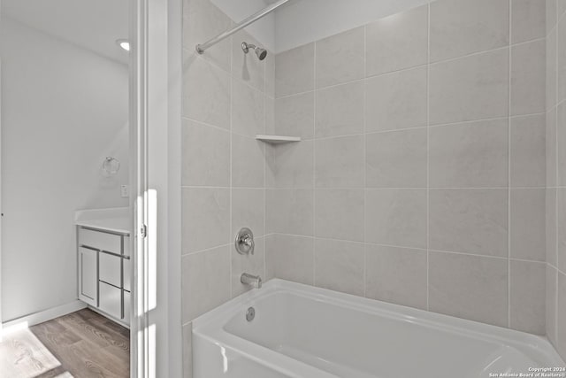 10719 Gilmore Gdn, San Antonio, TX 78109 - full bathroom featuring wood finished floors and bathing tub / shower combination
