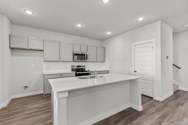 10719 Gilmore Gdn, San Antonio, TX 78109 - kitchen featuring dark wood-style floors, a sink, stainless steel appliances, and gray cabinets