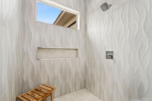 bathroom featuring tile walls and tiled shower