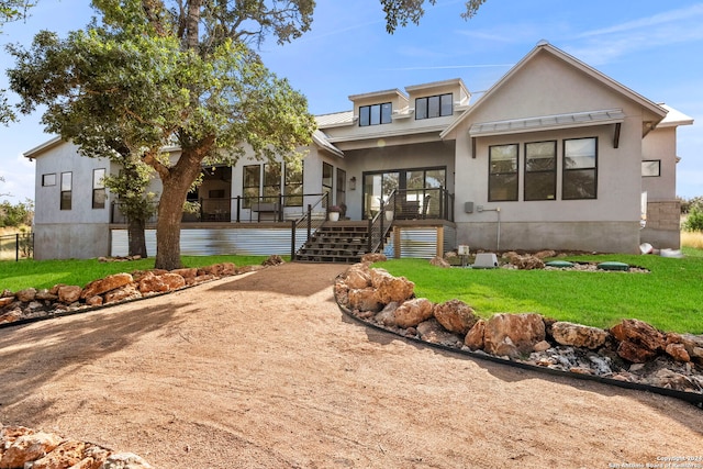 view of front of home with a front yard and covered porch