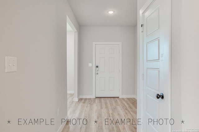 hallway with light hardwood / wood-style floors